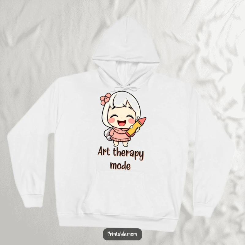 Funny mom hoodie with a cheerful character giggling while holding a crayon, offering warmth and creative inspiration.