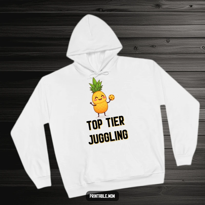 Funny Hoodie showing a giggling pineapple juggling small round fruit with its leafy top.